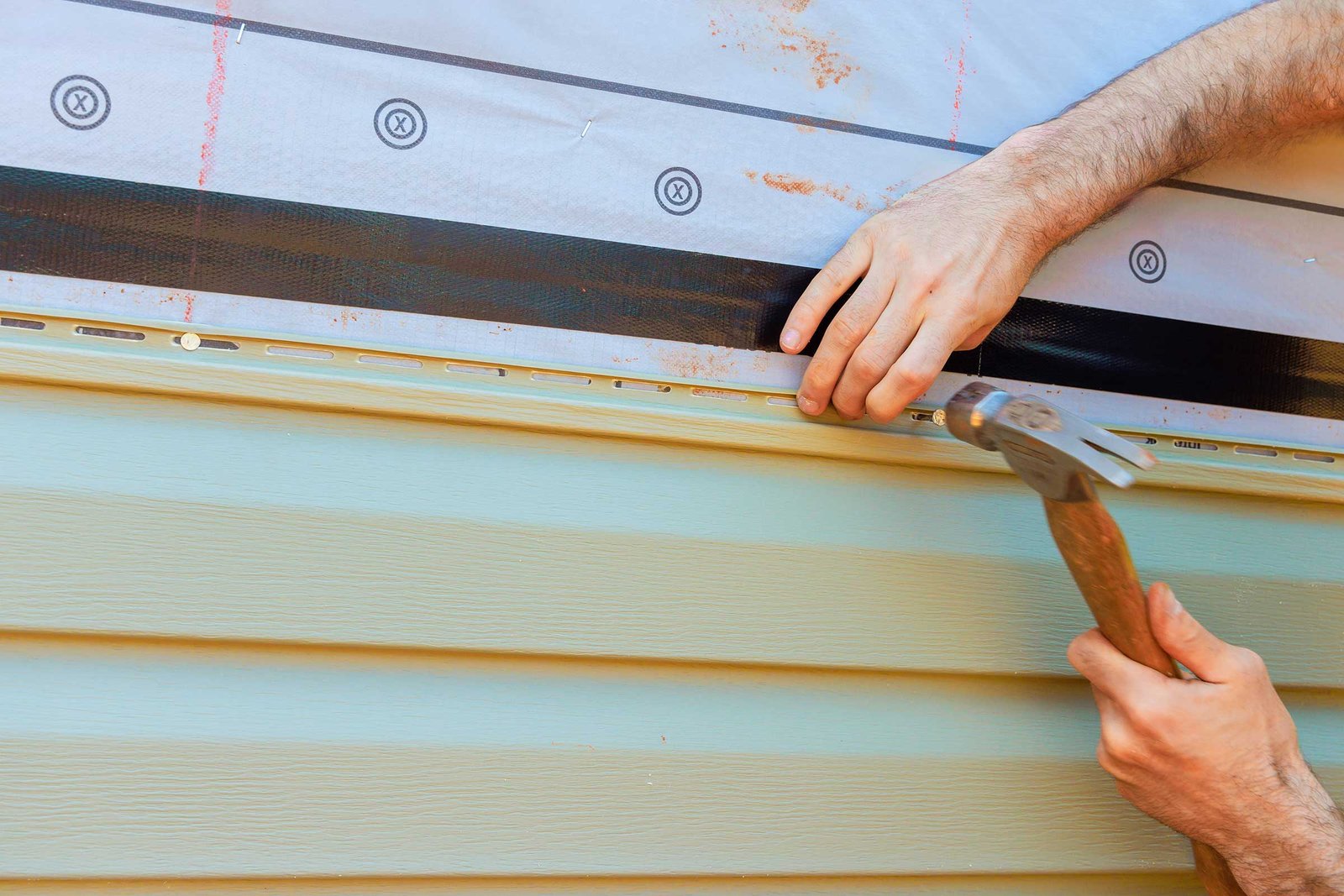 Man Installing Siding On A Home